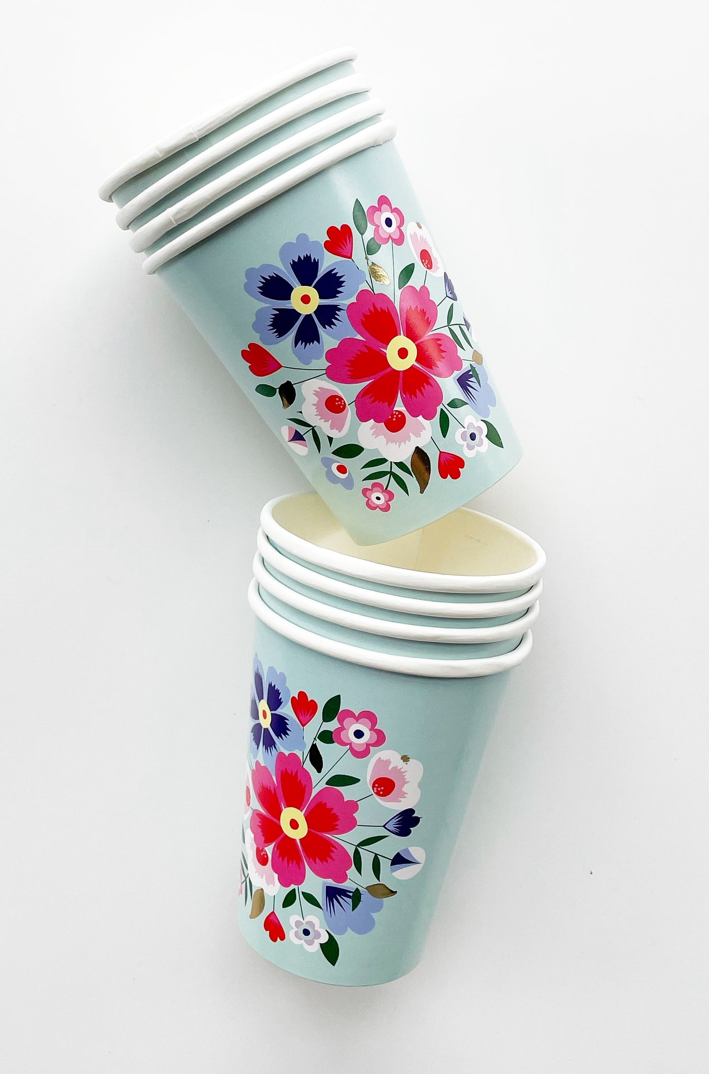 Blossom Party Kit paper party cups. The flower/floral pattern includes green, red and blue colours. 