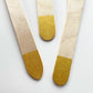 Close up of the gold dipped wooden utensils. This cutlery set includes knives, spoons and forks.