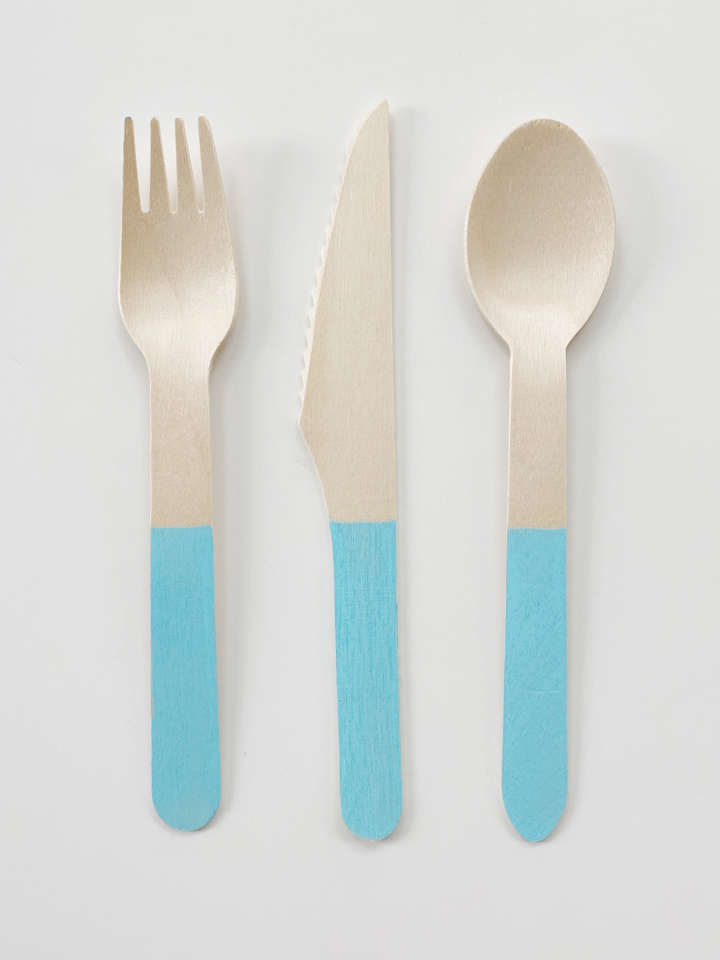 Blue dipped wooden utensils. This cutlery set includes knives, spoons and forks.