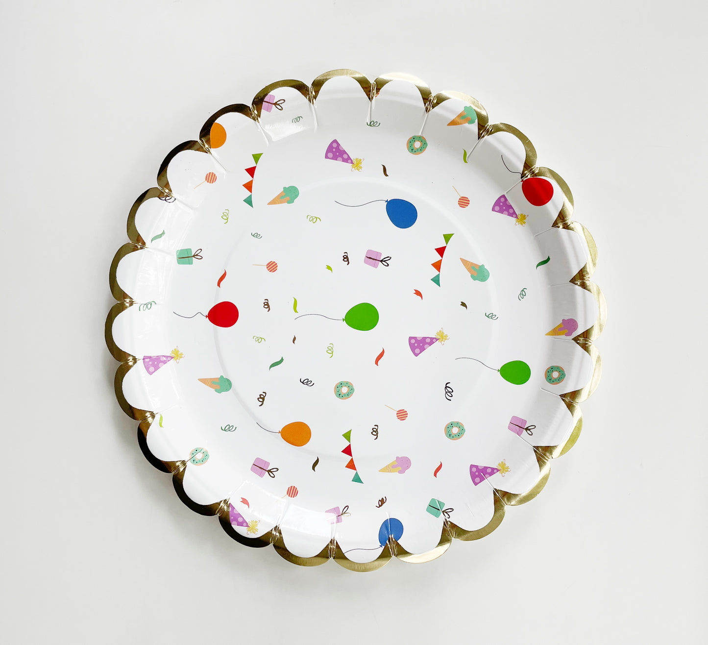 The small Celebration paper party plates have a gold foil scalloped edge. The celebration pattern features green, orange and blue balloons, ice cream cones, party hats, party garlands, birthday gifts and donuts.