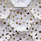 The large paper party plates are in the shape of a hexagon. The plates are a pale blush pink colour with gold foil detail. This image shows multiple plates.
