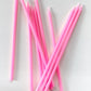 Ten tall bright pink birthday cake candles.