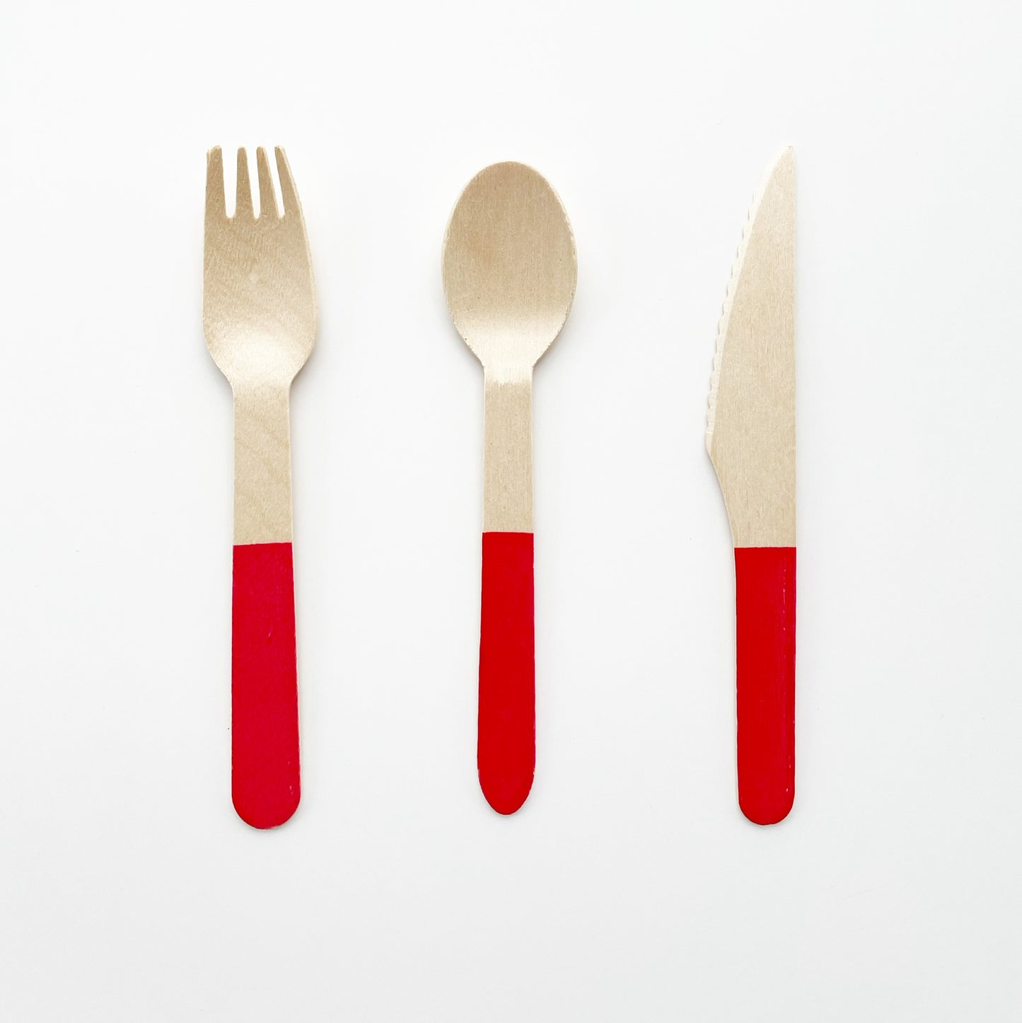 The Blossom party kit's red dipped wooden utensils, including a fork, spoon and knife.