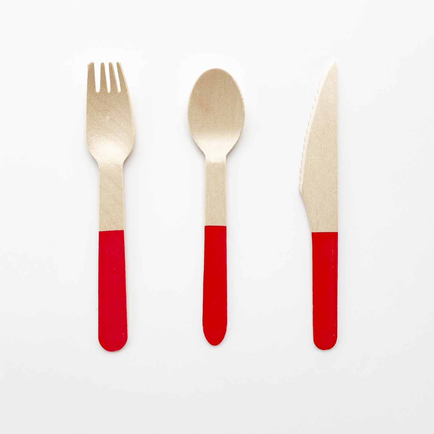 Red dipped wooden utensils. This cutlery set includes knives, spoons and forks.