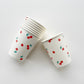 The cherry paper party cups feature a red, green and white cherry print.