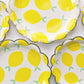 The Lemon Party Kit's paper party plates. The lemon pattern includes yellow, green and white colours. The party plates have gold scalloped edges.