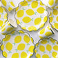 The Lemon Party Kit's paper party plates and cups. The lemon pattern includes yellow, green and white colours. The party plates have gold scalloped edges, and the party cups are trimmed with gold.