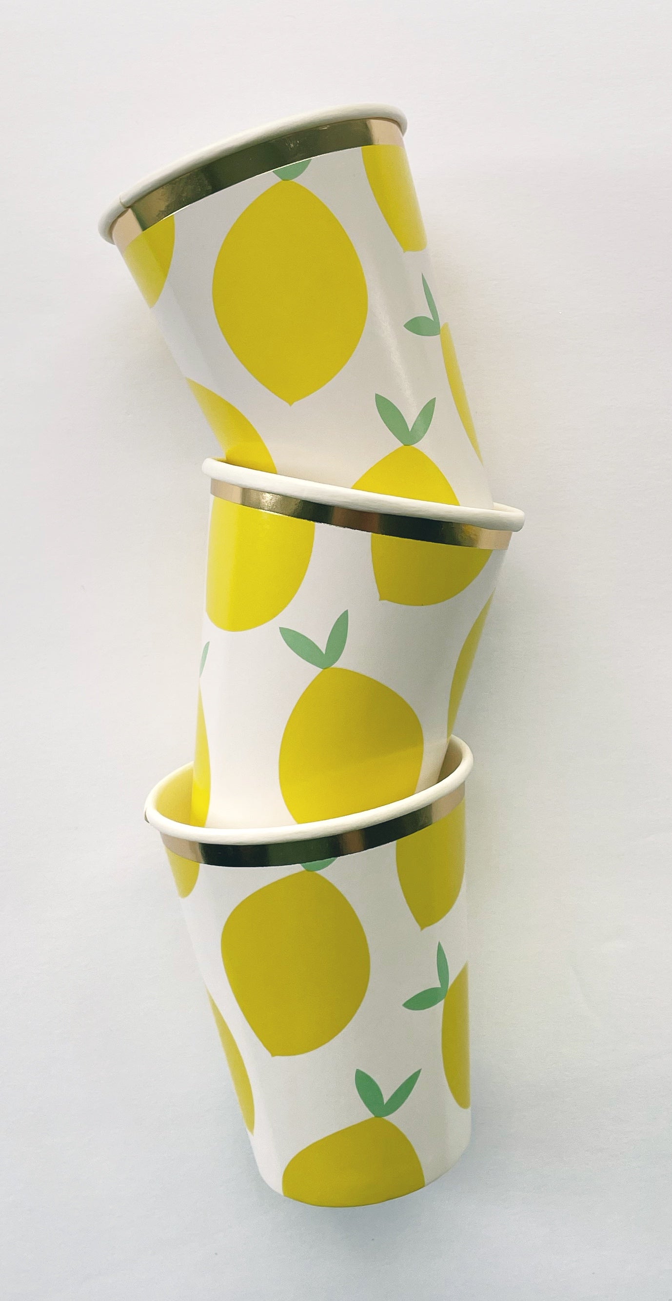 Lemon Party Kit paper party cups. The lemon pattern includes yellow, green and white colours with a metallic gold trim.