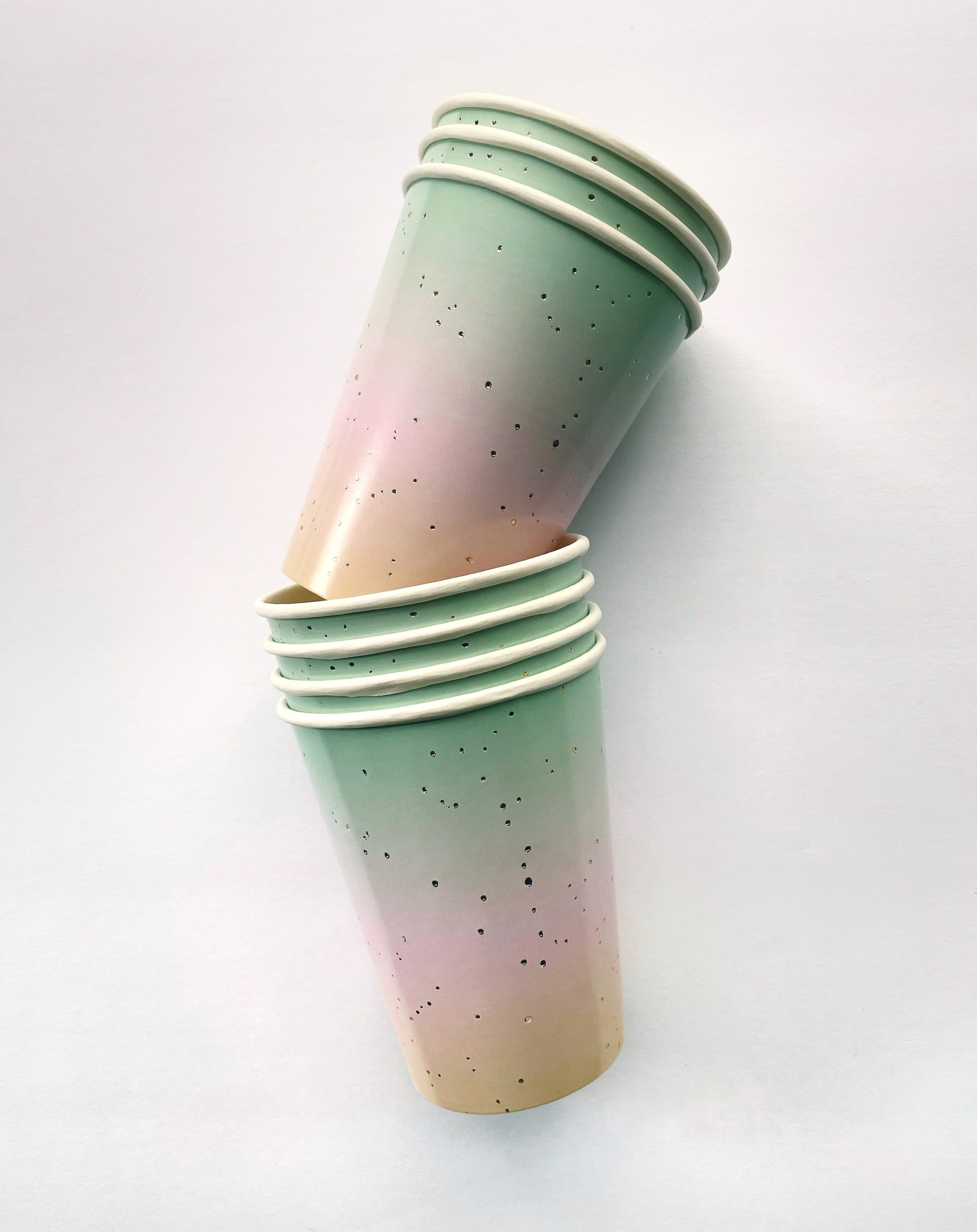 The Ombre Party Kit's pastel pink, yellow, green and gold paper party cups.
