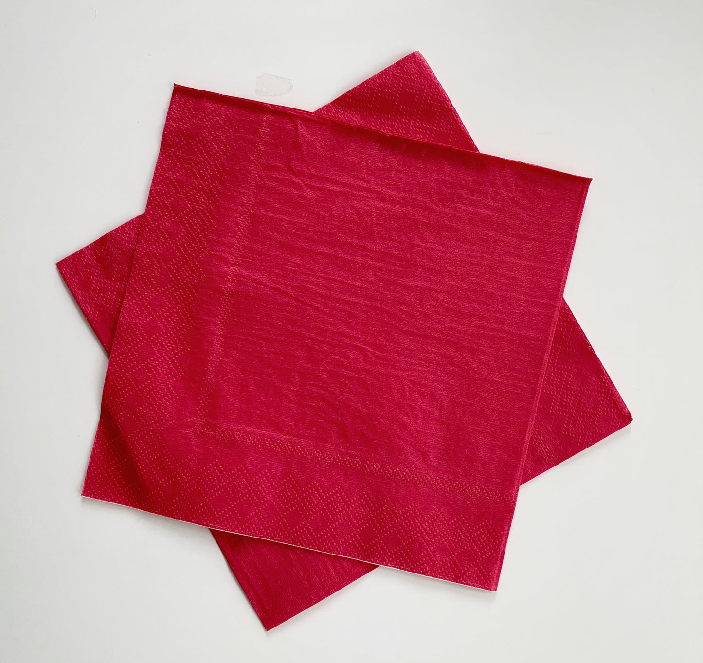 The paper party napkins are a bold red colour.