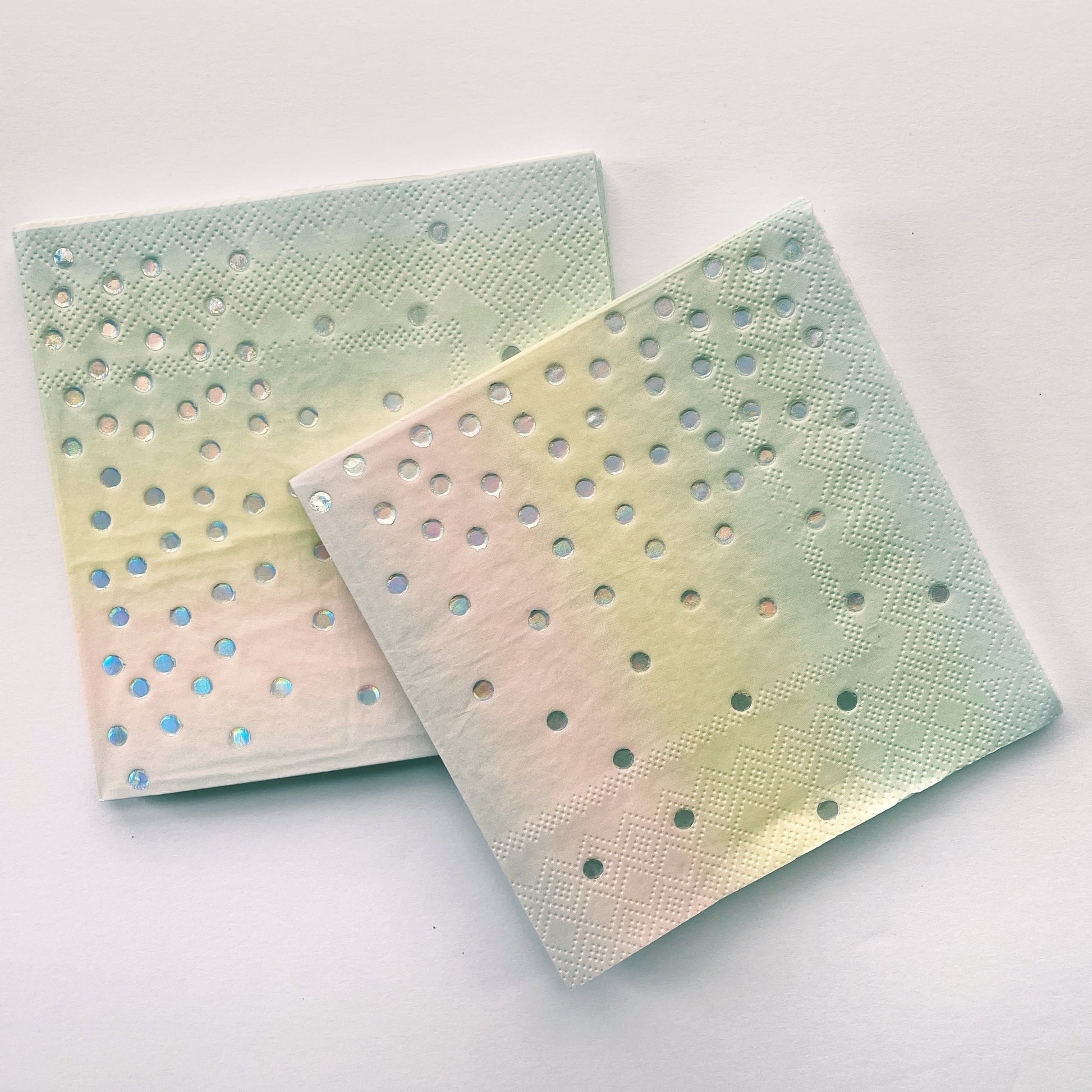 The Ombre Party Kit's pink, yellow, green and silver paper party napkins.