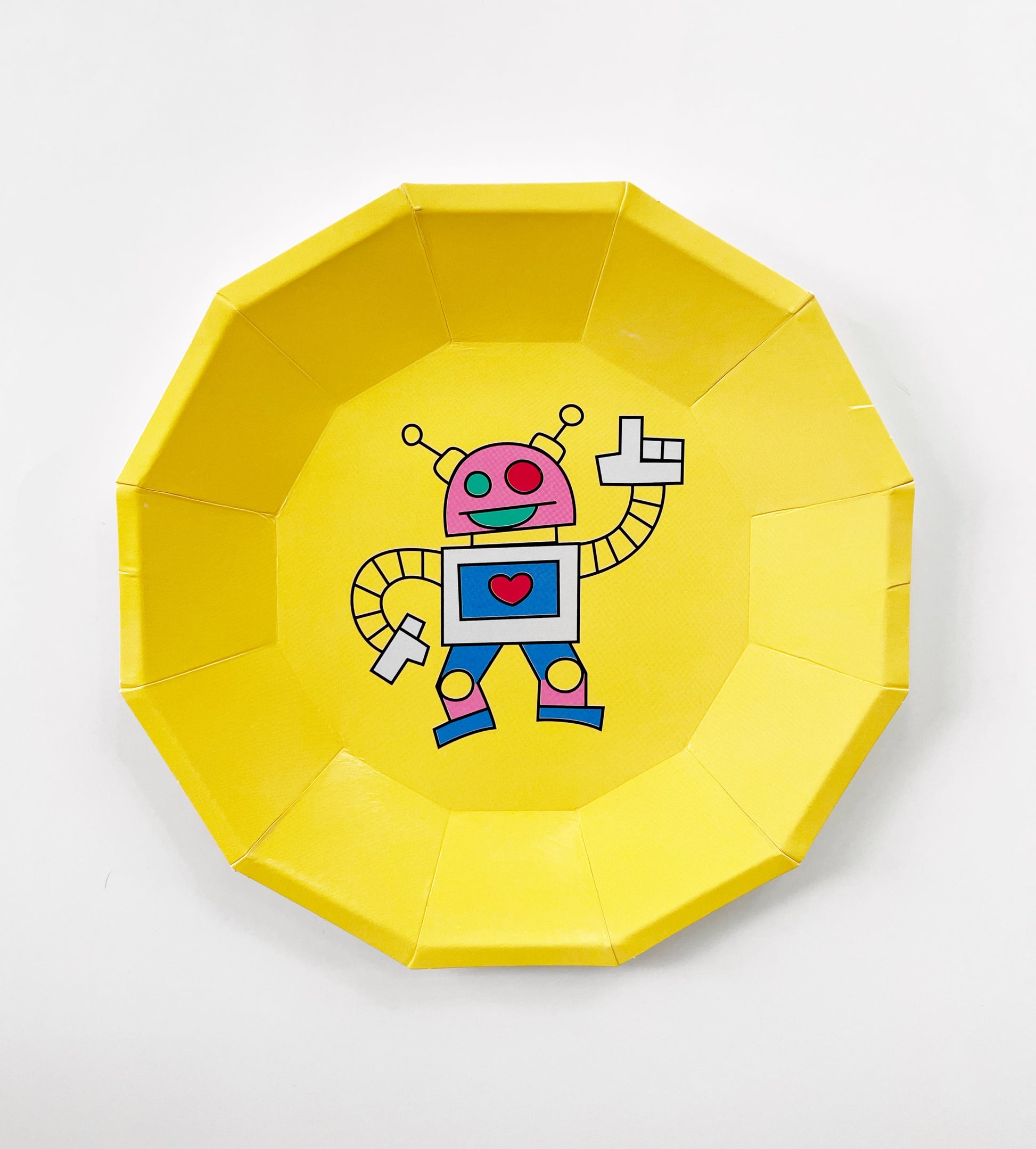 The small yellow robot paper party plates are in the shape of a dodecagon. The robot pattern includes planets, robots, spaceships and clouds in green, blue, red, yellow and pink colours.